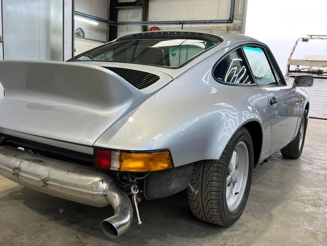 Porsche 911 Diamond Silver finish and rear spoiler with reassembly still in progress