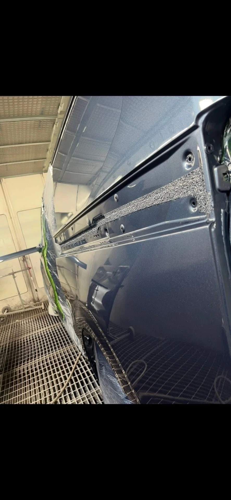 Ford Transit Custom freshly painted blue loading door, close-up on a stand