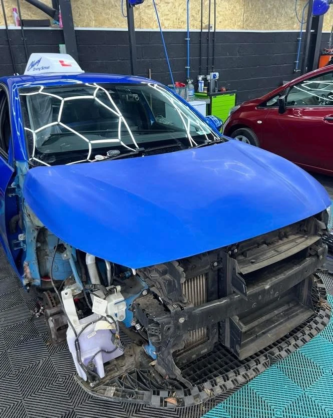 Peugeot 208 front stripped down with bumper, wing and headlamp removed for repair