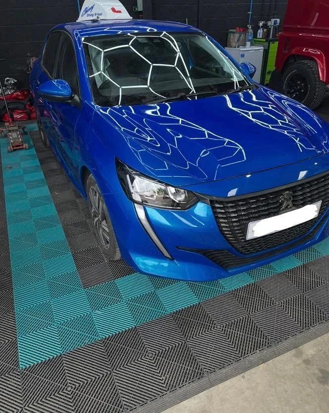 Peugeot 208 completed front accident repair with replacement headlamp and colour-matched blue bodywork