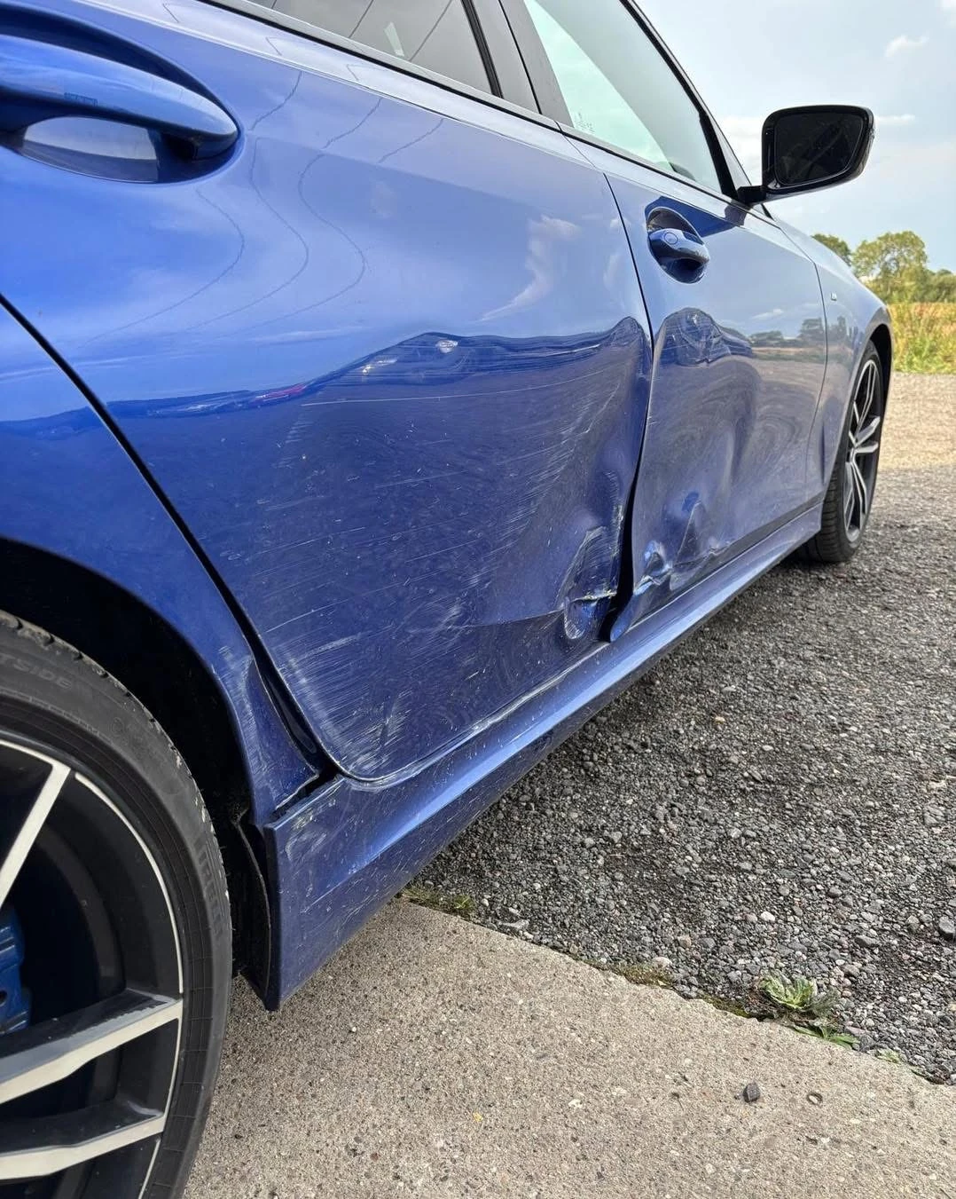 BMW 330i accident damage along the driver's front and rear doors
