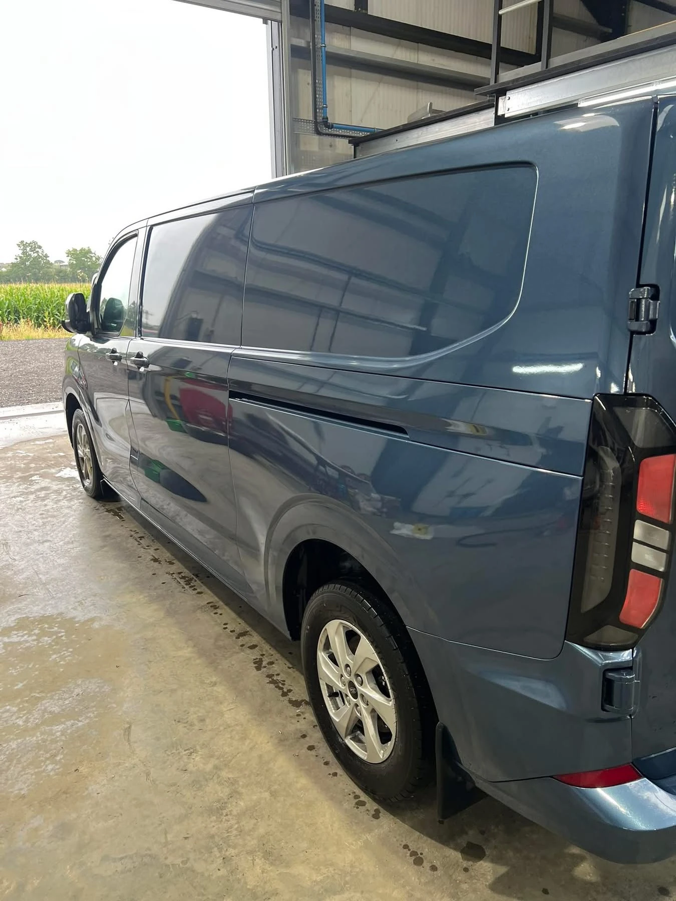 Ford Transit Custom completed passenger-side body repairs, rear three-quarter view