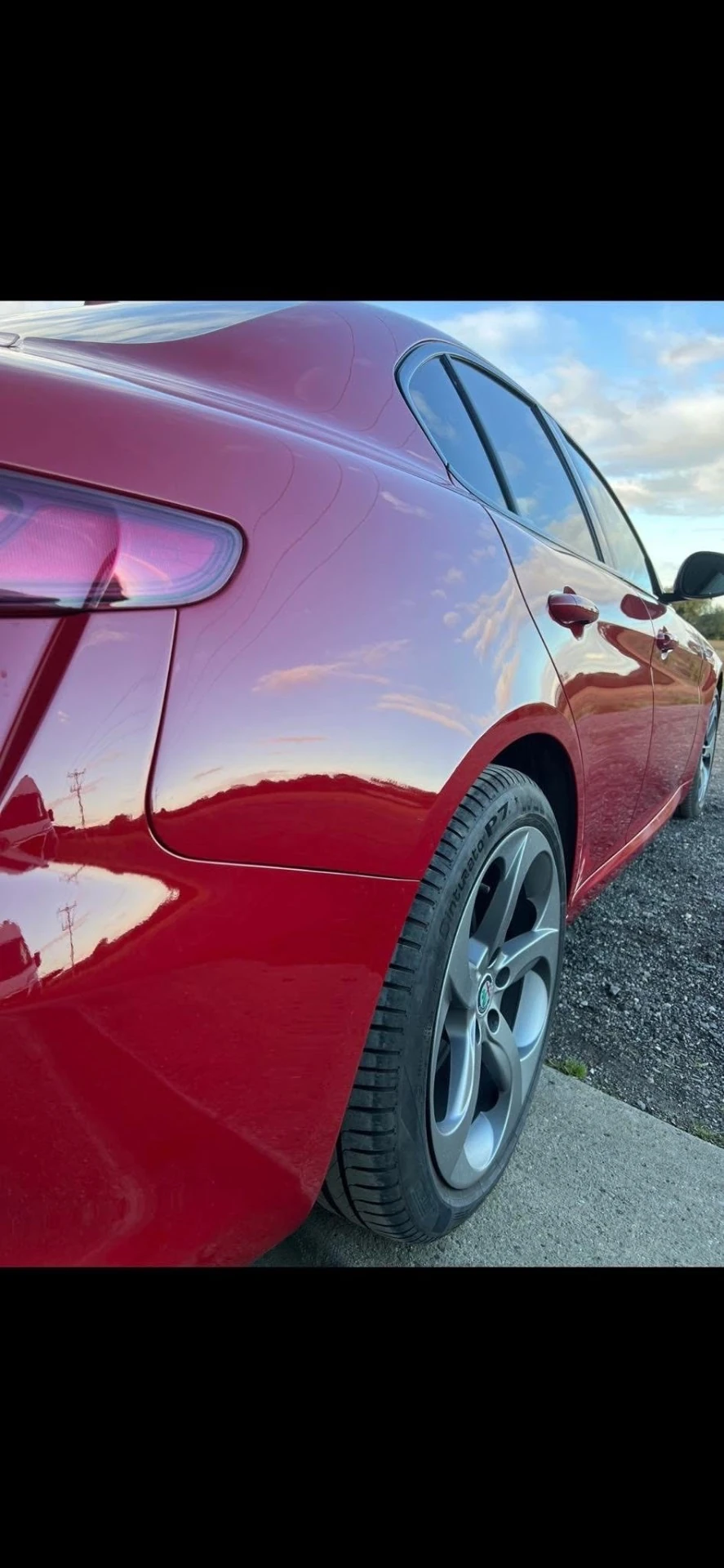 Alfa Romeo Giulia completed rear quarter and bumper repair with glossy red paintwork, rear three-quarter view
