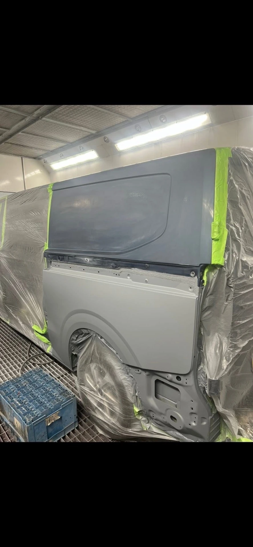 Ford Transit Custom replacement rear quarter panel prepared and masked in the spray booth