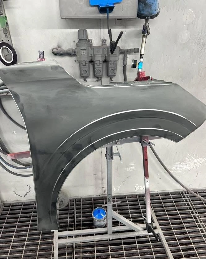 Peugeot 208 replacement front wing prepared on a stand in the spray booth